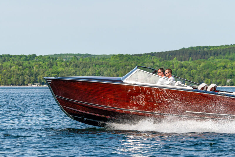 Custom fabricated wooden boat with laminated glass